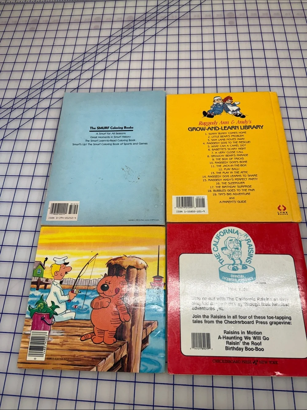 VTG lot 4  1980 books California raisins smurfs coloring raggedy Ann heathcliff